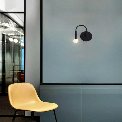 Wall Sconce with Curved Metal Arm and Rotating Exposed Bulb Holder
