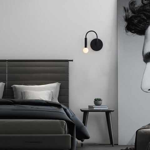 Wall Sconce with Curved Metal Arm and Rotating Exposed Bulb Holder